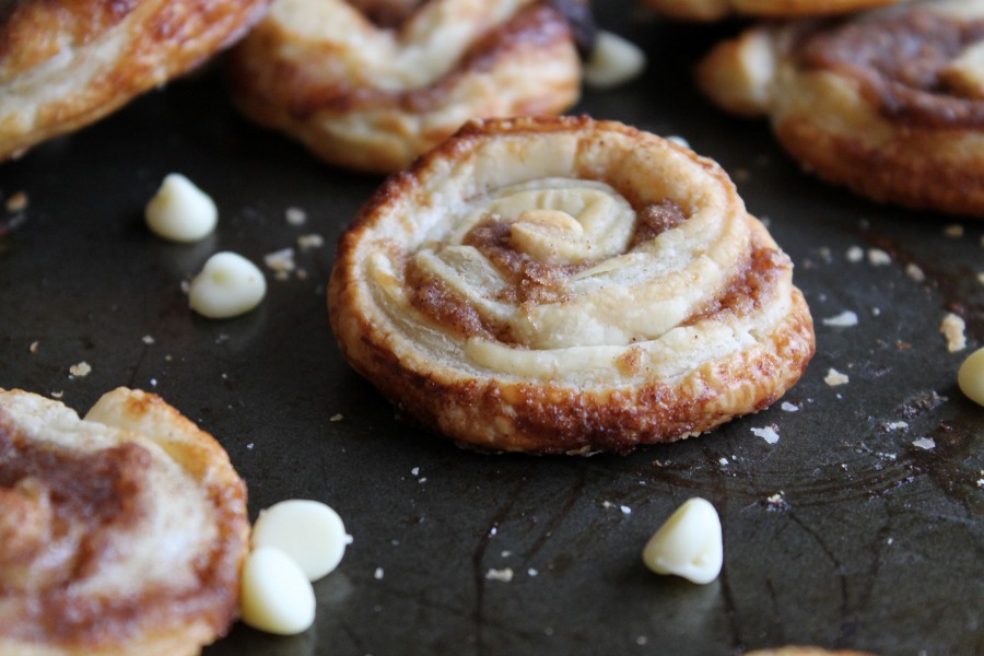 A white chocolate cinnamon swirl on a black platter