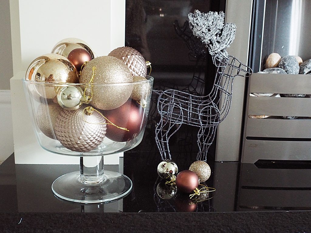 A bowl full of baubles and a silver wire reindeer