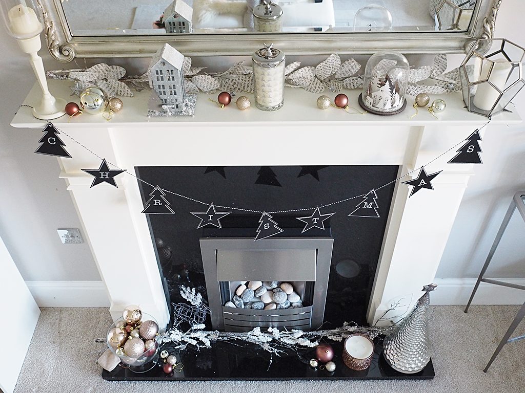 A top down view of Christmas decorations on a mantlepiece