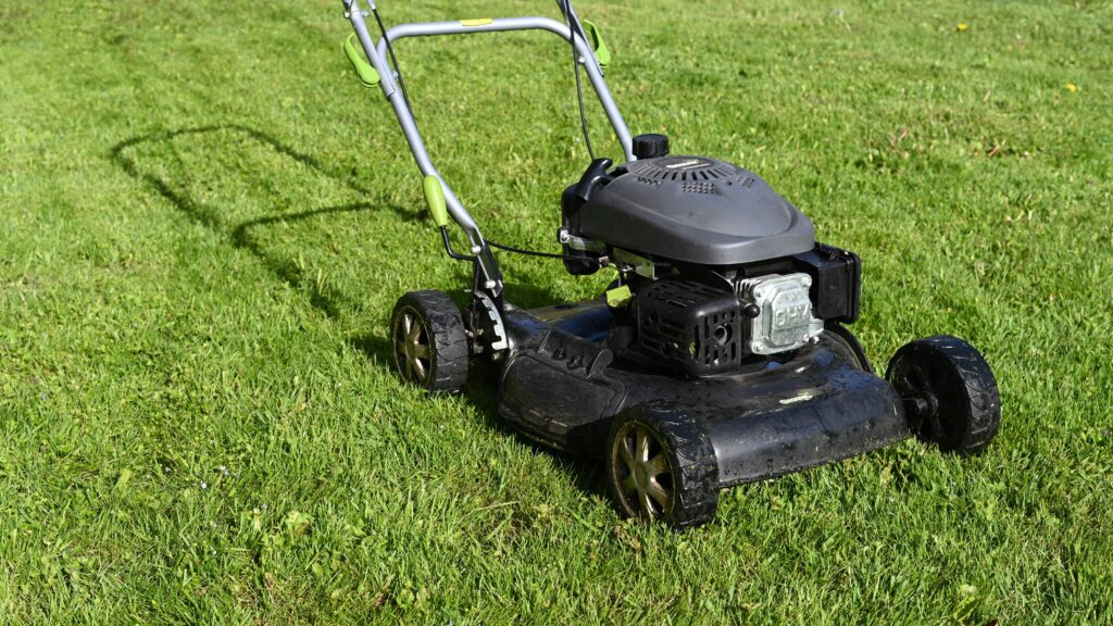 A lawn mower sitting on the grass.