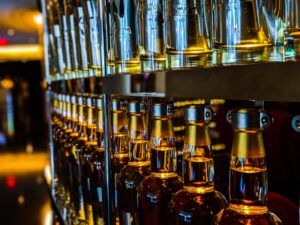 The supportive teens strategically line up the bottles on a shelf.