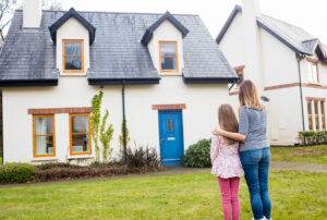 A woman and a girl standing in front of a Tiny Home.