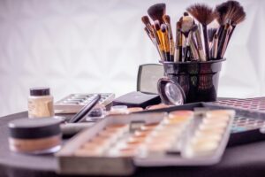 Makeup brushes and cosmetics tips on a table for busy moms.