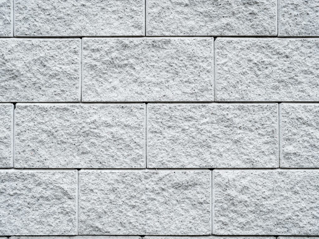 A close up of a white brick wall showcasing modern advancements in concrete technology.