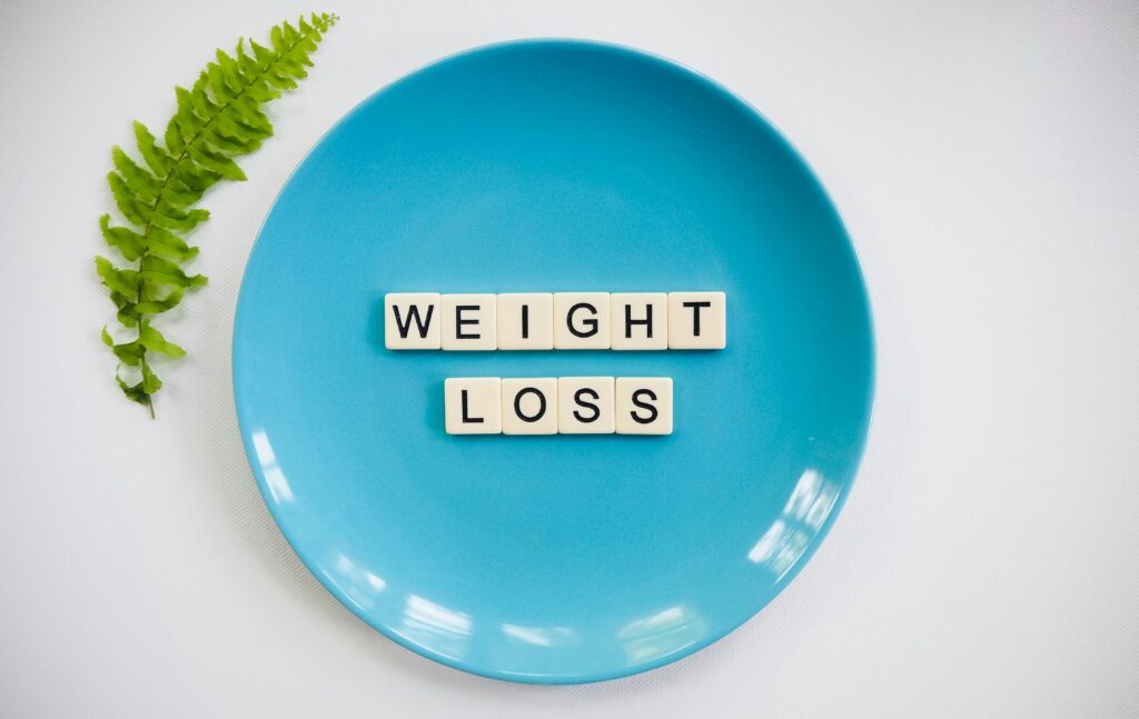 A blue plate with the vital steps for weight loss written on it.