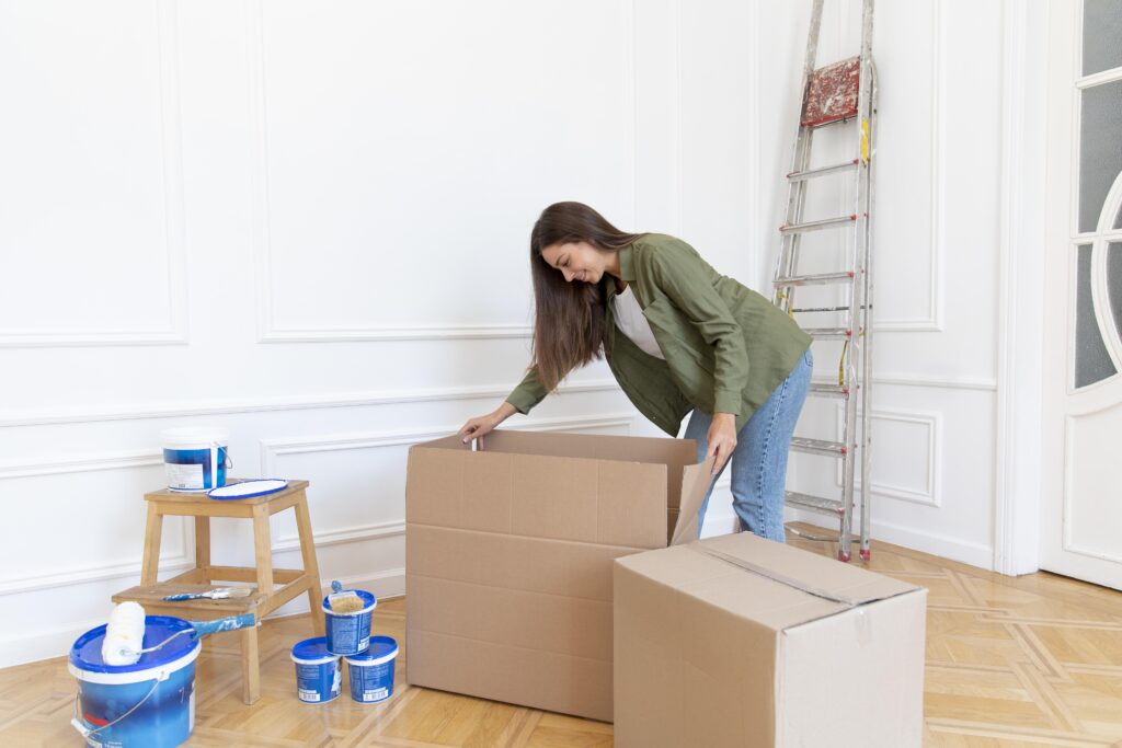 A woman is moving into a new home, ensuring her items are safe.