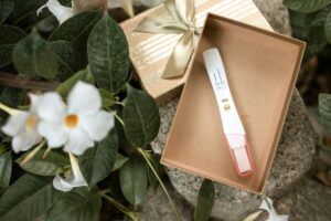 A gift box with a pen and a flower in it, symbolizing hope for those facing infertility.