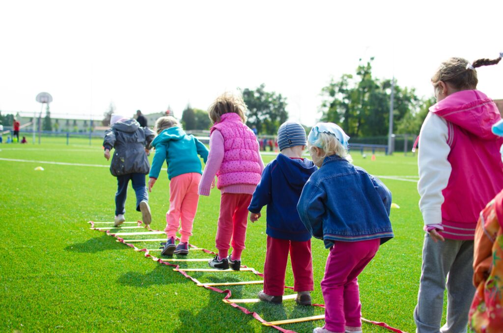 A group of children on a soccer field learning physics in easy ways.