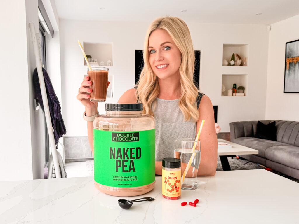 A woman holding a jar of pea protein.