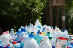 A large pile of plastic bottles from adapting suppliers on a table.