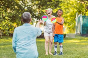 Family integrating fitness by playing Frisbee in a park.